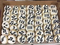 a box filled with decorated cookies covered in music notes