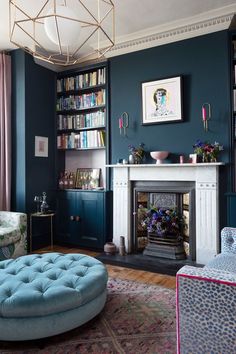 a living room filled with furniture and a fire place next to a book shelf full of books