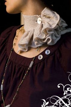 a woman wearing a necklace with buttons on it