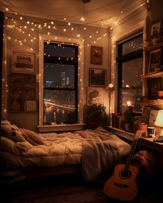 a bedroom with string lights and a guitar on the bed in front of an open window