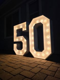 the number 50 lit up in front of a building