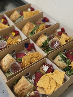 six boxes filled with different types of food on top of a table next to each other