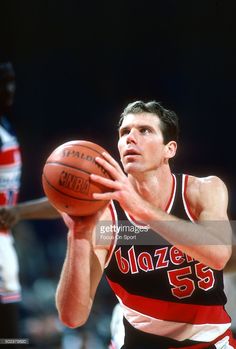 a basketball player holding a ball in his hand