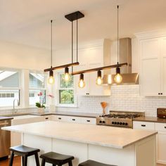 a kitchen with an island and three stools