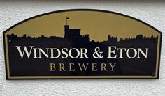 a black and gold sign that says windsor & eton brewery on the side of a building