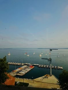 boats are docked in the water at a marina on a sunny day with blue skies