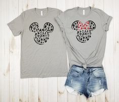 two t - shirts with mickey and minnie mouse heads on them, one is grey