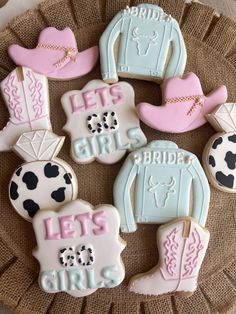 decorated cookies are arranged on a plate with cowboy boots and cowgirl's names