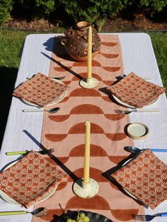 the table is set with plates and utensils