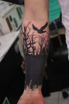 a person with a bird tattoo on their arm