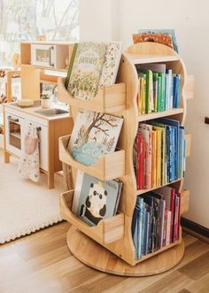 there is a book shelf with many books on it in the living room and children's playroom