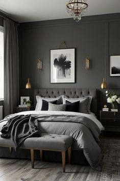 a bedroom with grey walls and wooden flooring, gray bedding, gold accents