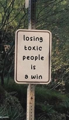 a white sign that says losing exotic people is a win on the side of a road