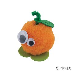 an orange with googly eyes and a green leaf on top