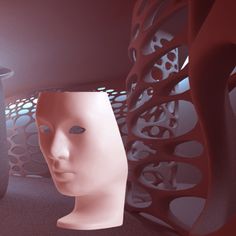 a white mannequin's head in front of a red sculpture