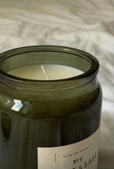 a close up of a candle on a table with a label that says no 6 sage