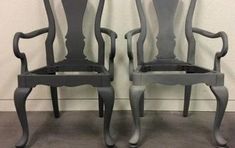 two gray chairs sitting next to each other