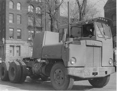 an old truck is parked on the side of the road