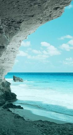 an ocean view from the inside of a cave