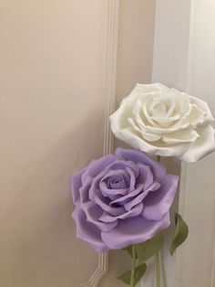 two white and purple flowers are in a vase