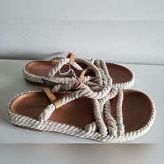 Woven Rope Design Contoured Footbed For Added Support Beige Flat Sandals With Cushioned Footbed, Beige Flat Sandals Casual Style, Casual Beige Flat Sandals, Comfortable Cream Sandals For Vacation, Cream Round Toe Sandals For The Beach, Cream Sandals For The Beach, Cream Sandals With Cushioned Footbed For Vacation, Cream Sandals With Cushioned Footbed For Beach, Cream Cushioned Sandals For Vacation