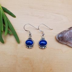 Visit our on-line shop at: Etsy.com/shop/AlbuquerqueDesigns *sterling silver earrings *dangles / drops / hooks / ear wires *southwestern jewelry *blue lapis / blue stone *calibrated pre-cut stones: 9x7mm oval shape *all jewelry items are made to ship, slight variations in stones will occur comparing to pictures. *size of a penny is 19mm or a dime is 18mm in diameter for comparing size with jewelry items. *handcrafted in USA *free small convenient gift box *free shipping in US, ship from US witho Dainty Blue Drop Earrings, Dainty Blue Round Earrings, Blue Nickel Free Sterling Silver Earrings, Blue Sterling Silver Drop Earrings, Nickel-free Blue Sterling Silver Earrings, Blue Nickel-free Sterling Silver Earrings, Dainty Blue Earrings For Gifts, Dainty Blue Dangle Earrings, Dainty Hypoallergenic Blue Earrings