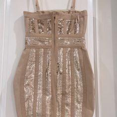 a tan dress with gold sequins on it