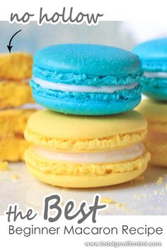 three macaroon cookies are stacked on top of each other with blue and yellow frosting