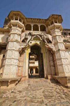 the entrance to an old building with stone pillars