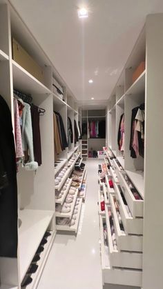 an empty walk - in closet with clothes and shoes