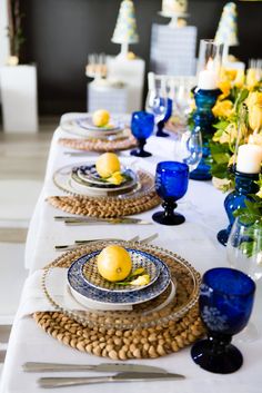 the table is set with blue and yellow dishes