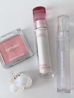 the contents of an assortment of cosmetics on a white surface, including lip balm, eye shadow and lipstick