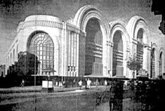 an old black and white photo of a large building with arches on the side of it