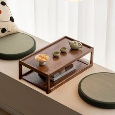 a coffee table with two bowls and plates on it