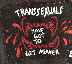 the back of a black jacket with red writing on it that says, transsexuals have got to get memeer