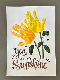 a yellow flower with the words you are my sunshine painted on it