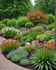 a garden with lots of colorful flowers and plants in the center, surrounded by brick pavers