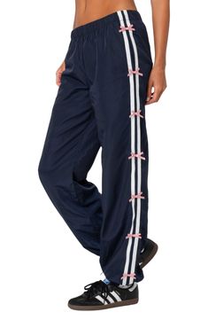 Get active in these sporty track pants designed with bow-trimmed stripes racing down the sides. Elastic waist Side-seam pockets 100% polyester Machine wash, dry flat Imported Navy Sporty Pants With Three Stripes, Sporty Navy Pants With Three Stripes, Sporty Navy Nylon Pants, Get Active, Pants Design, Nordstrom Store, Track Pants, Elastic Waist, Track