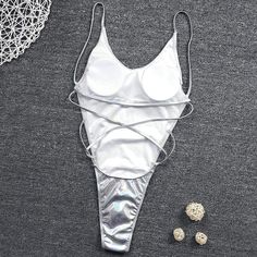 Metallic Glitter Light Silver One Piece Solid High Cut Beachwear QUICK DRY AND COMFORTABLE FABRIC - 82% polyester, 18% spandex. Length of clothing (from shoulder to bottom, measured vertically): S-25.2inch, M-26.0inch, L-27.2inch, XL-28.0inch. PERFECT FOR: Dancing, music festival clothes, rave outfits, concert clothing, party attire, club wear, EDM clothing, and other events. SHOW OFF YOUR BEST ASSETS: This hologram bodysuit features a sexy high leg cut with a scoop neck. Made of semi-stretchy, Metallic Swimwear For Vacation During Beach Season, Silver Swimwear For Summer Beach, Fitted Shimmer Swimwear For Beach, Silver Beach Swimwear For Summer, Metallic Swimwear For Vacation Beach Season, Silver Swimwear For Beach In Summer, Metallic Summer Swimwear For Vacation, Metallic Stretch Swimwear For Club, Stretch Shimmer Swimwear For The Beach