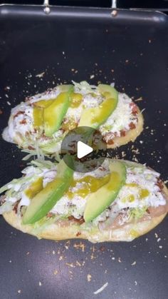 two flat breads topped with avocado and cheese