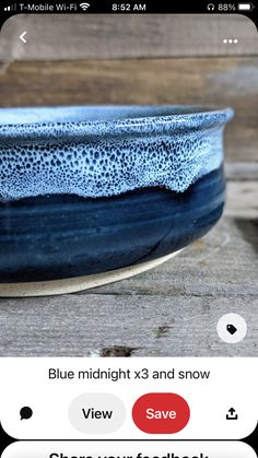 a blue bowl sitting on top of a wooden table next to a cell phone with the text blue midnight x3 and snow view above it