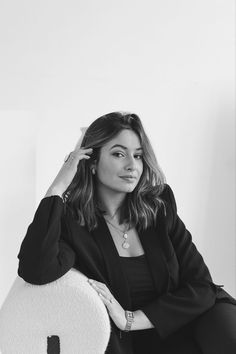 black and white photo of woman sitting in chair