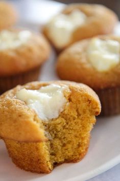 some cupcakes on a plate with white frosting and icing in them