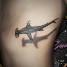 a black and white photo of a shark tattoo