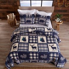 a bed with a blue and white checkered comforter set on top of it