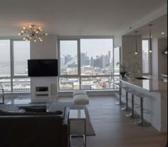 a living room filled with furniture and a flat screen tv mounted to the side of a wall