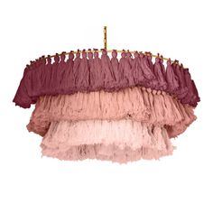 a chandelier hanging from the ceiling with pink and purple ruffles on it