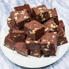 a white plate topped with pieces of chocolate fudge