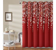 a red shower curtain with white flowers on it