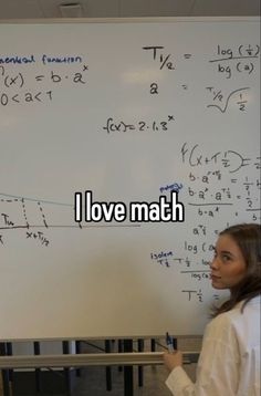 a woman standing in front of a whiteboard with writing on it that says i love math